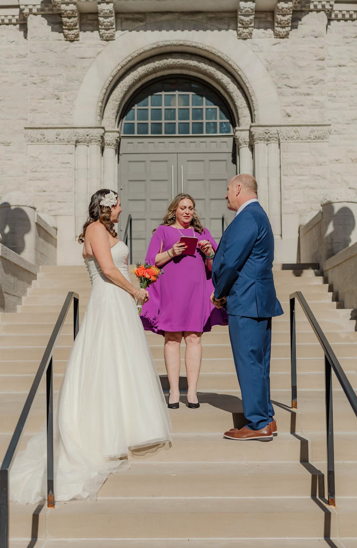 Phalynn Powers officiating an outdoor wedding ceremony for a couple